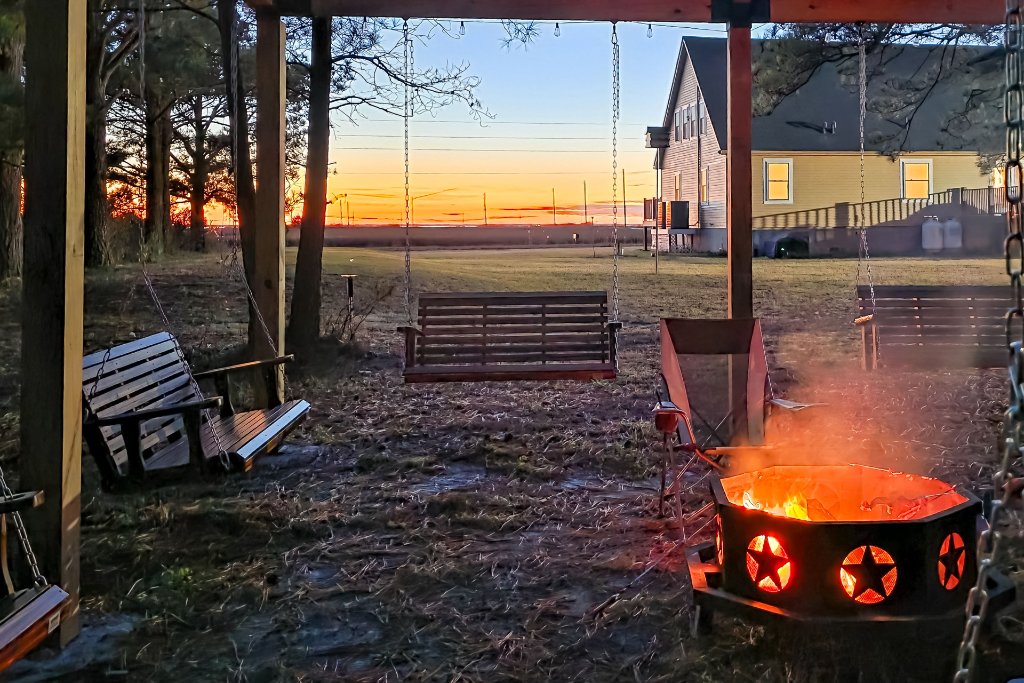 The Bayside Escape at sunset — the fire pit and pergola