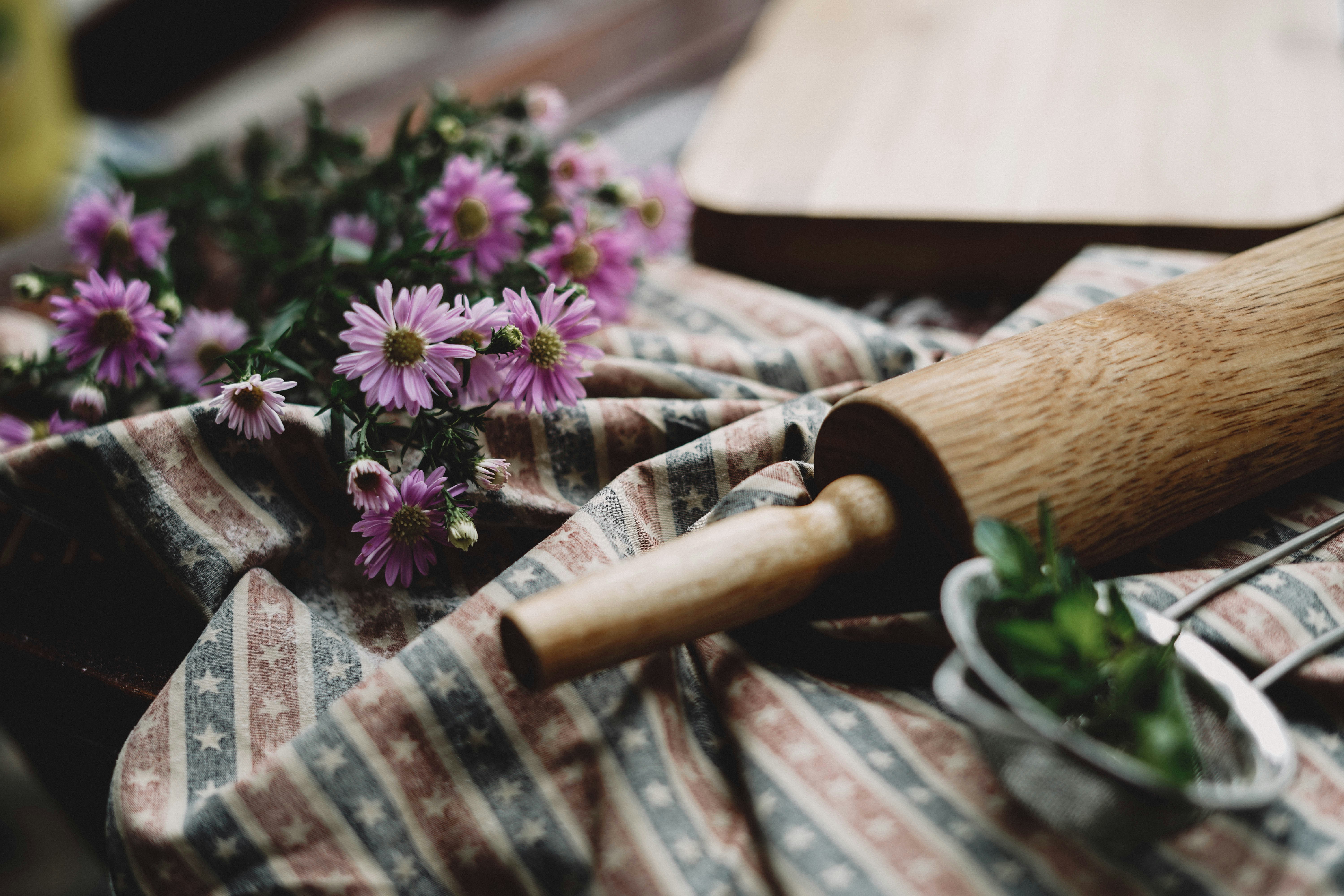 Artisan baking tools and flowers on a rustic table