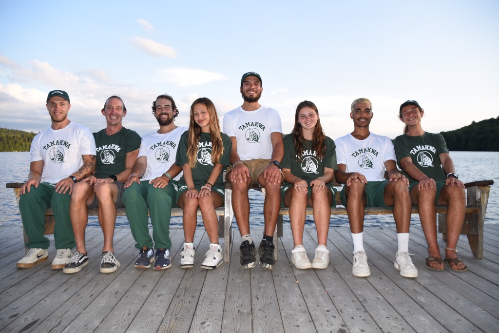 Friends wearing Tamakwa clothing on a dock