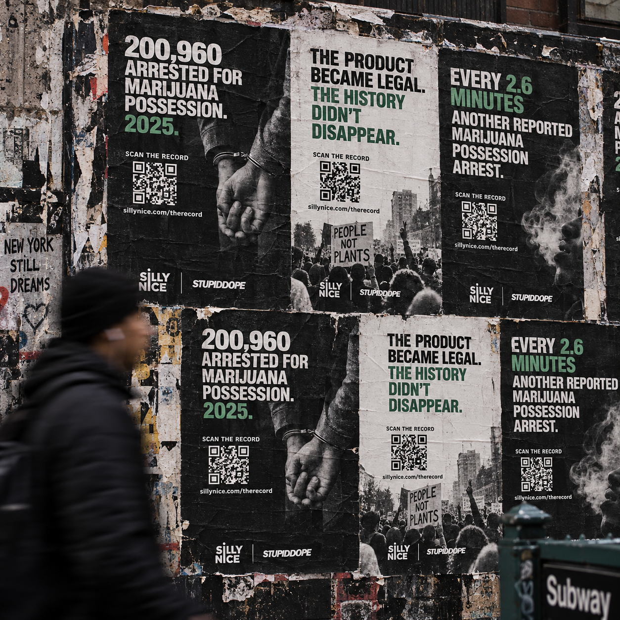 THE RECORD street poster campaign in New York City: wheatpasted black-and-white posters on a construction hoarding showing 200,960 marijuana possession arrests in 2025, with QR codes reading SCAN THE RECORD and Silly Nice | stupidDOPE branding