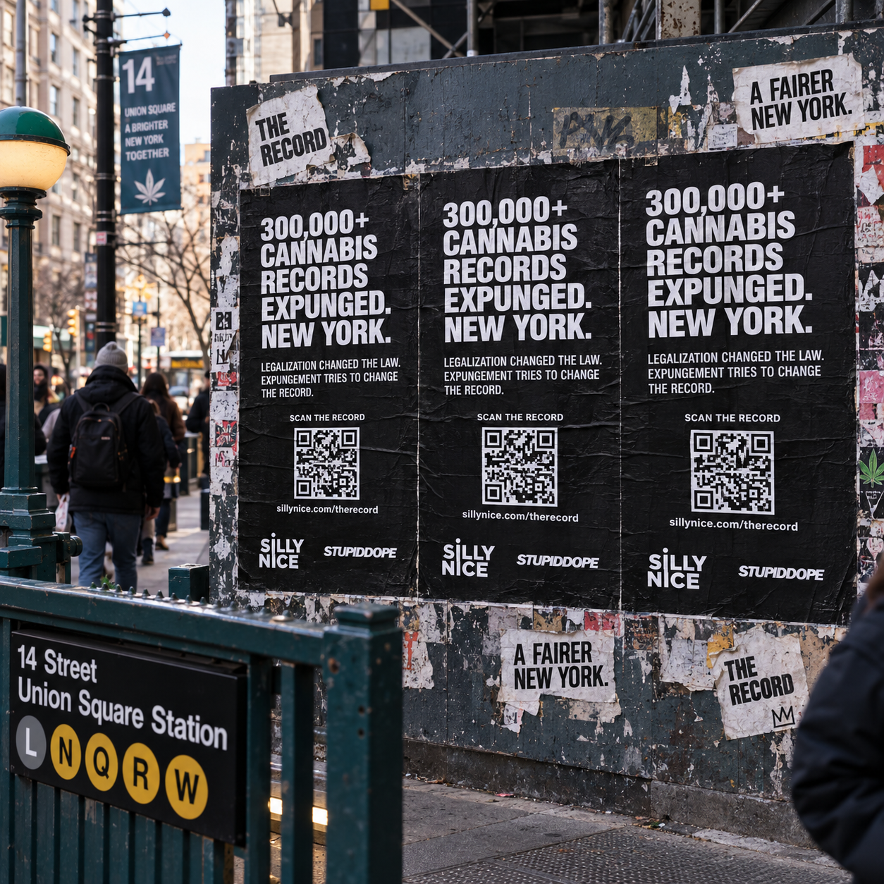 THE RECORD street-poster campaign in New York City — wheatpasted cannabis arrest statistics poster on a construction hoarding