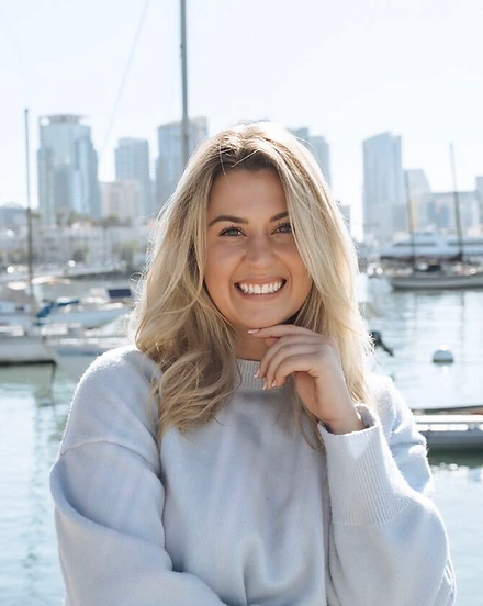 Portrait of Melissa Ottum, smiling by the San Diego harbor