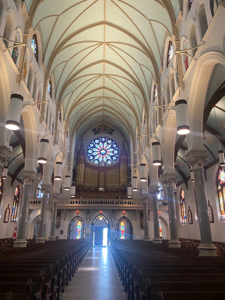 Interior nave with stone columns and rose window