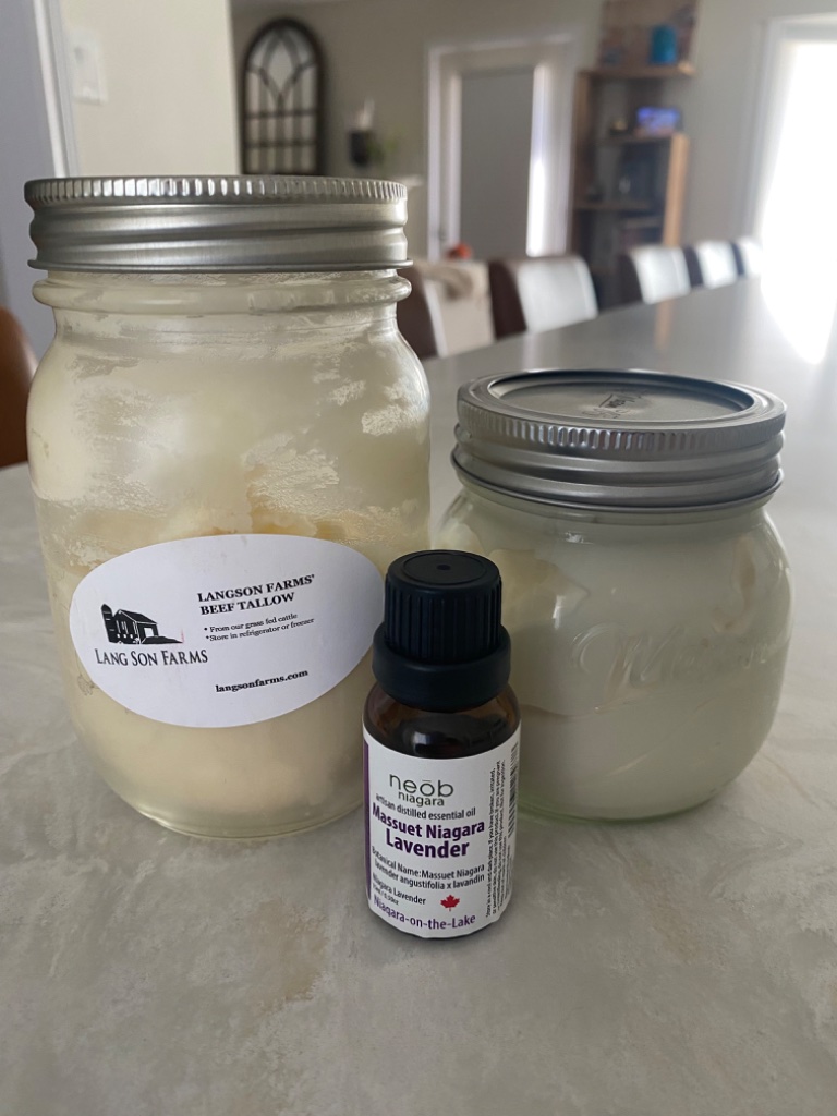 Beef tallow, lavender essential oil, and finished hand cream in mason jars