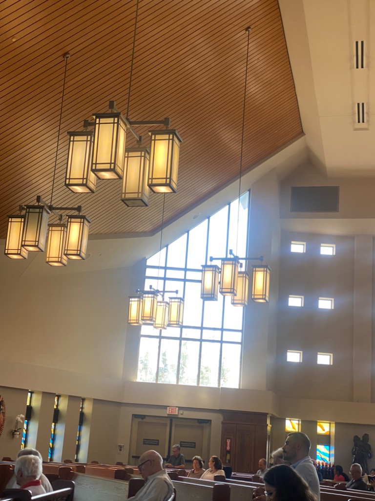 Sanctuary with pendant light fixtures and wooden ceiling