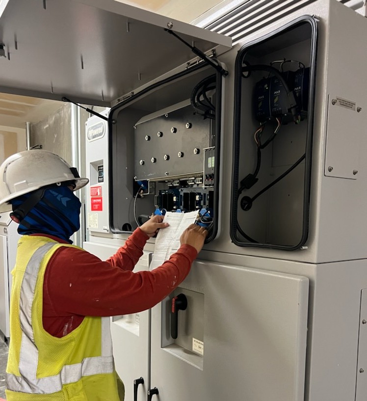 Technician inspecting electrical panel