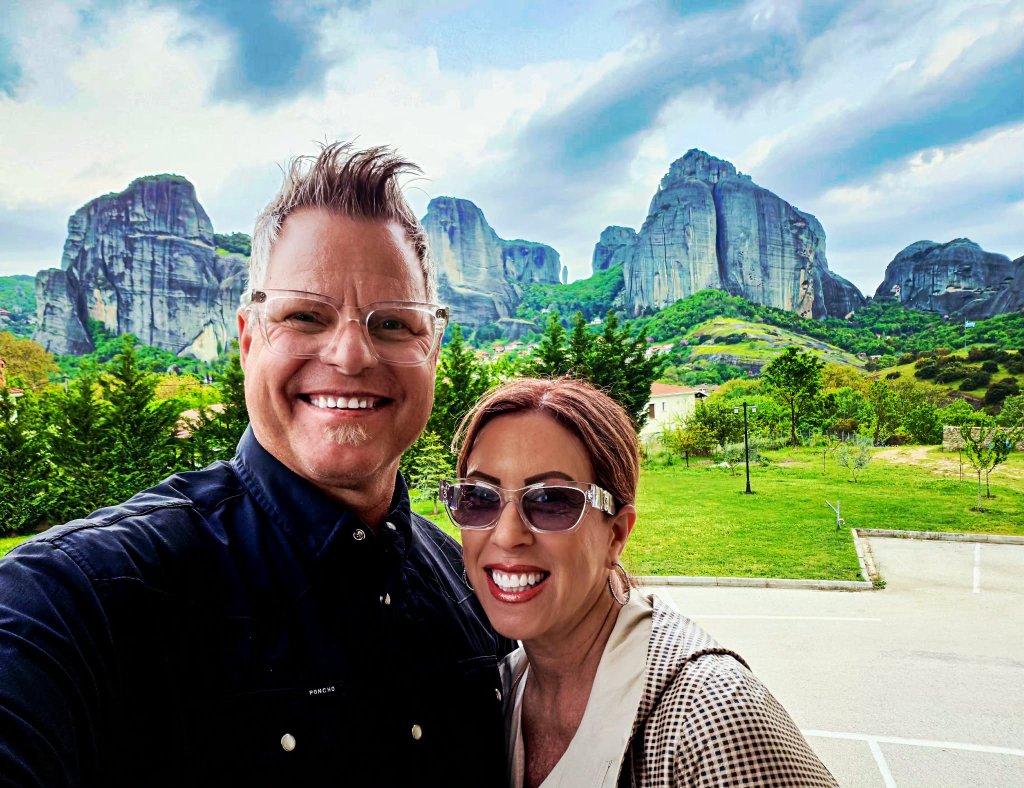 Couple selfie at Meteora — dramatic rock formations