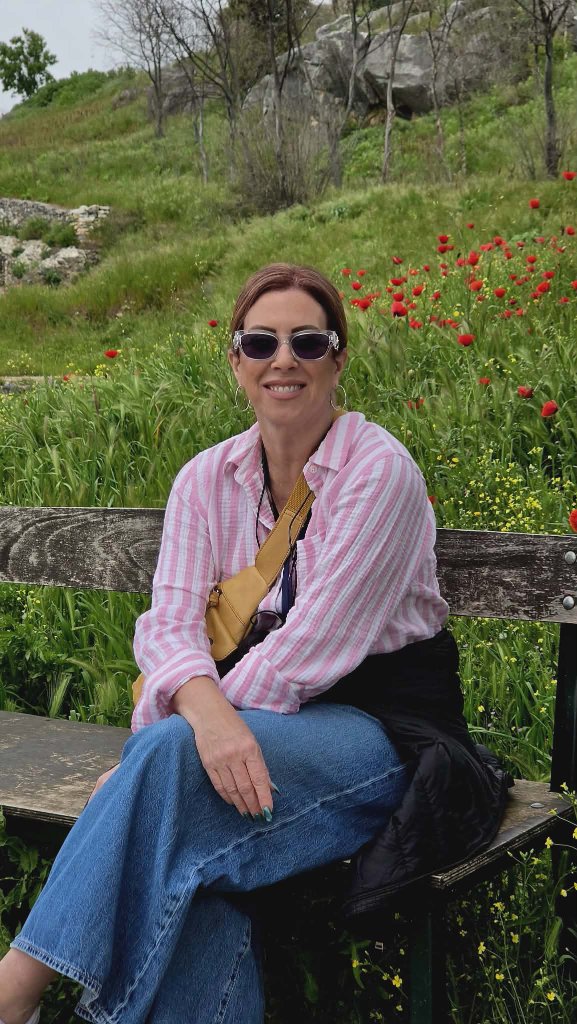 Lady among red poppies — ancient ruins