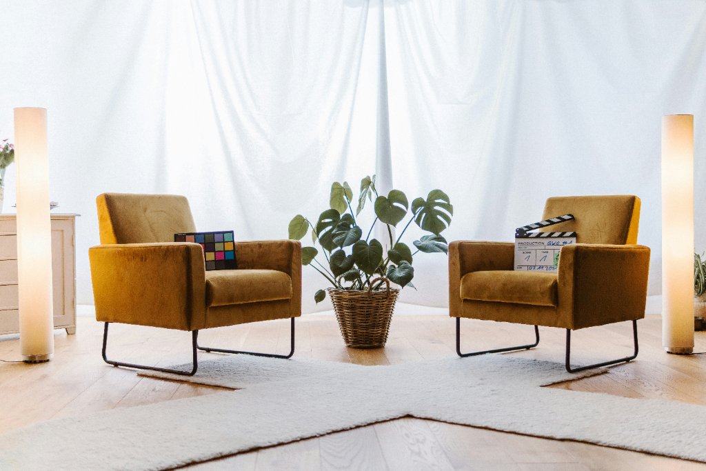 A warm, inviting therapy space with two mustard-yellow armchairs facing each other