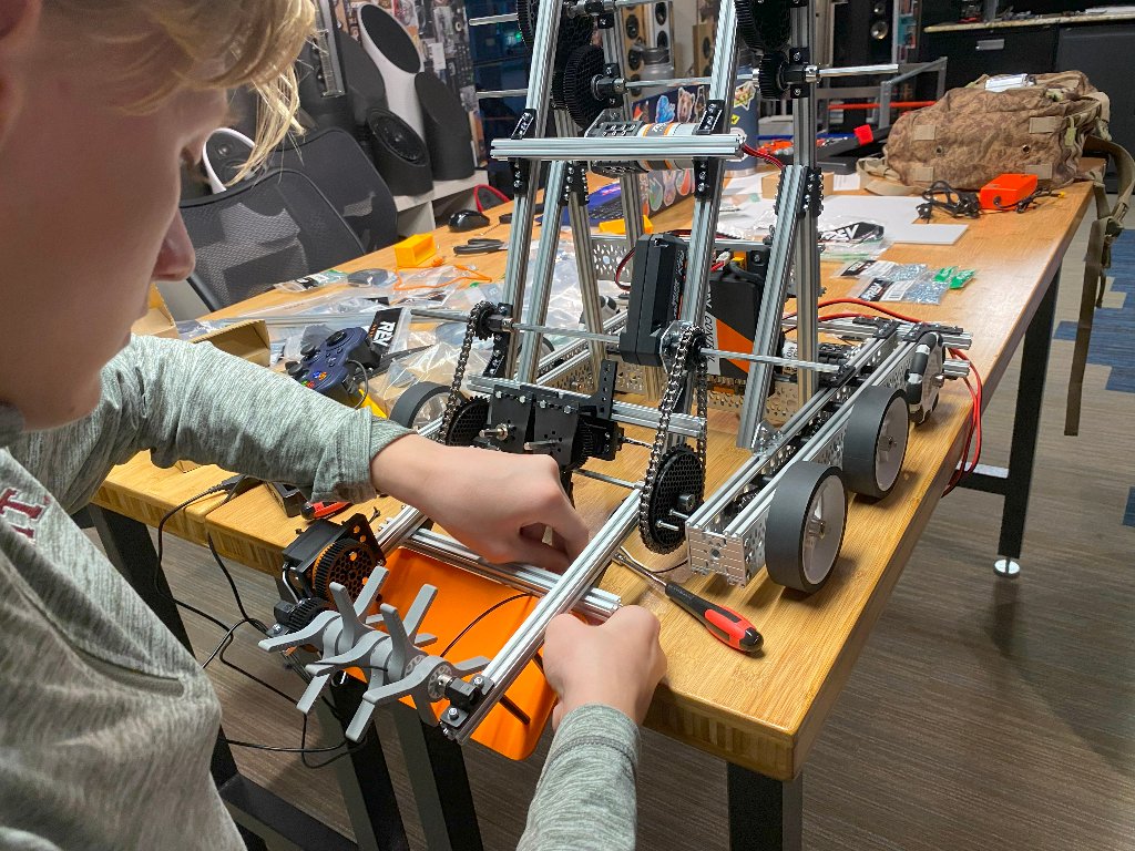 Kids building robots in a workshop