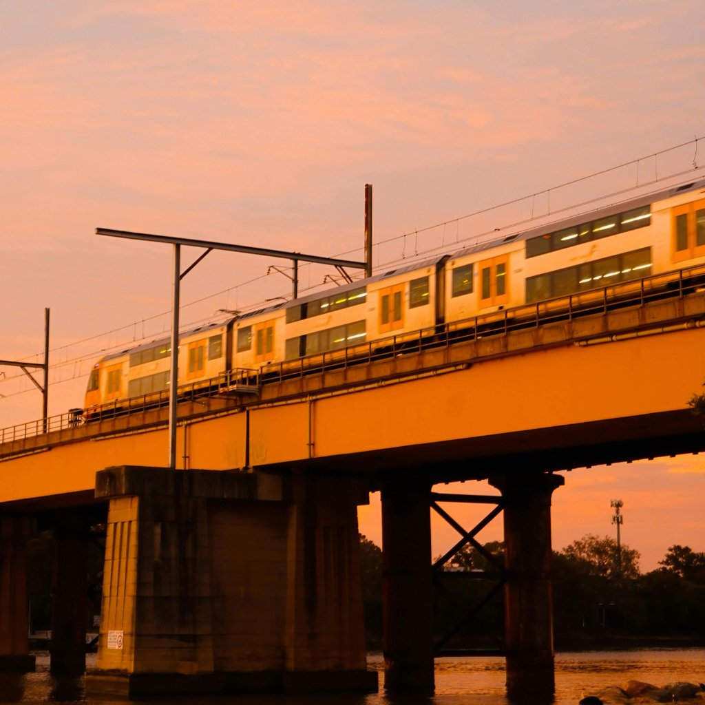 Train on bridge at sunset