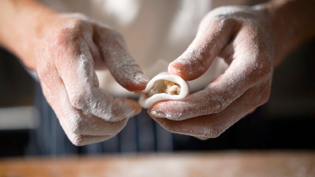 Hand folding a dumpling