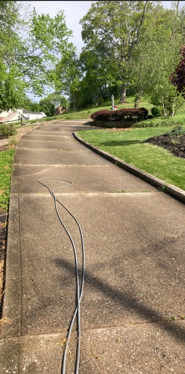 Stained dirty concrete driveway before cleaning