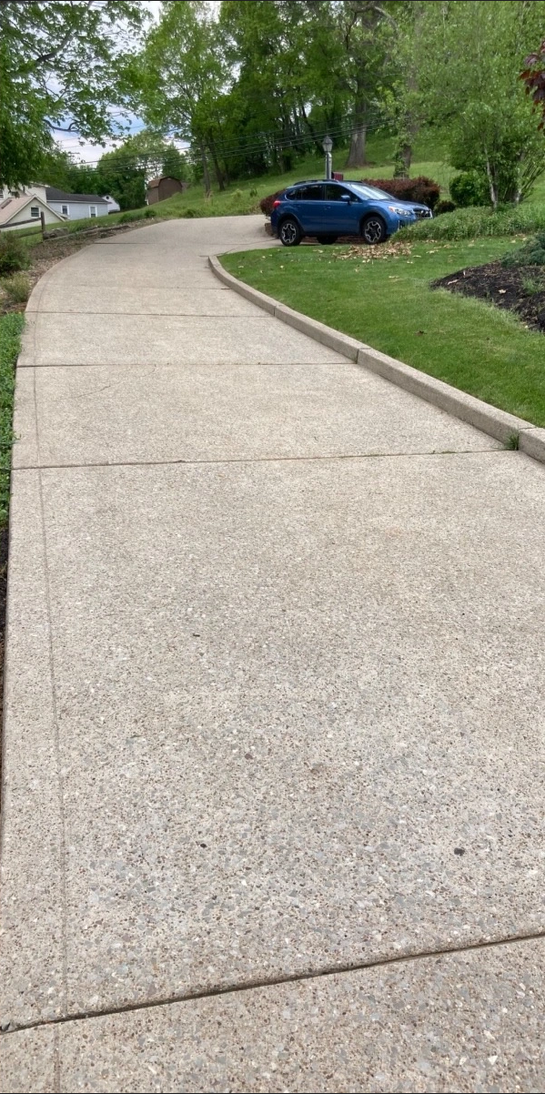 Bright clean concrete driveway after pressure washing