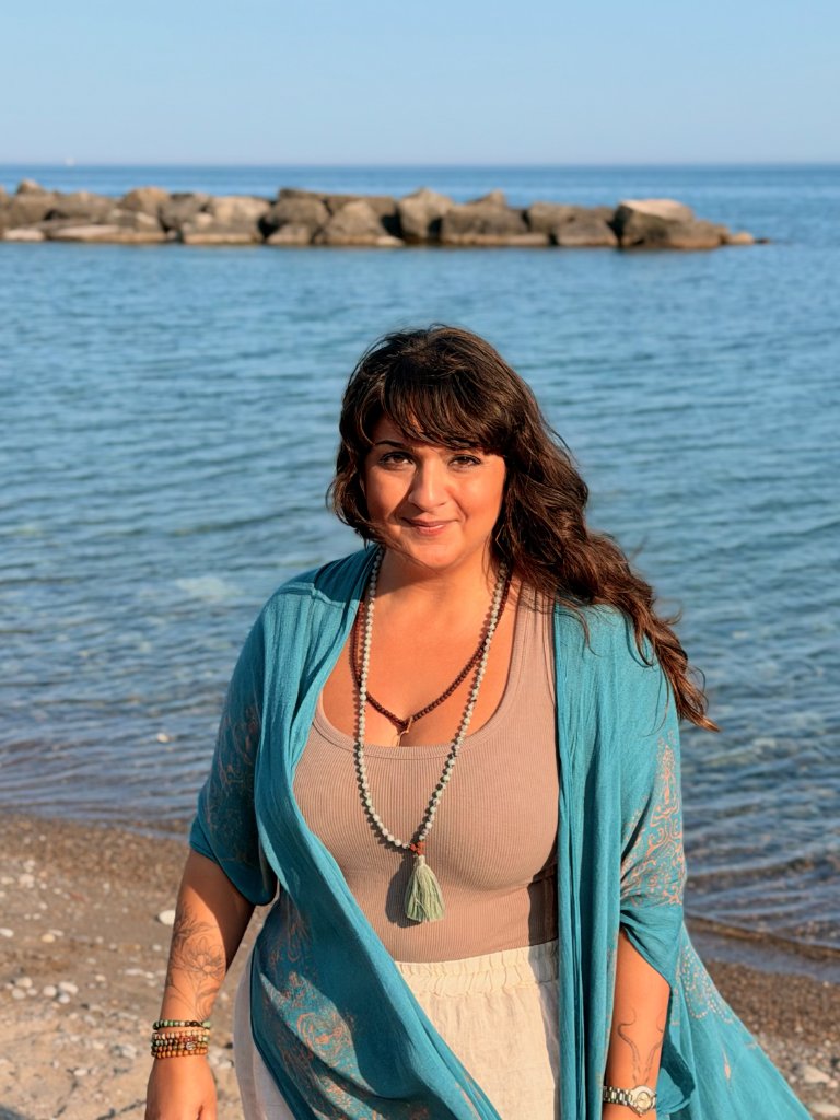 Nellie standing on a beach, smiling gently