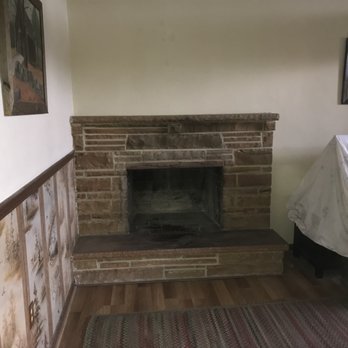 Chimney cap installation — new stainless steel cap on brick chimney