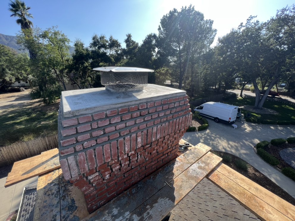 Chimney rebuild in progress — new brick and mortar work