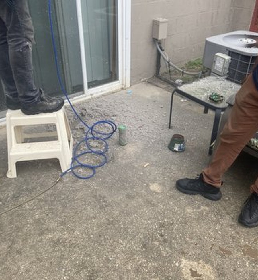 Air duct technicians servicing HVAC system — on-site job