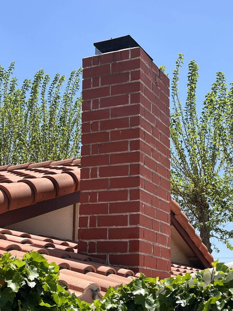 Chimney inspection — technician inspecting duct connection on exterior