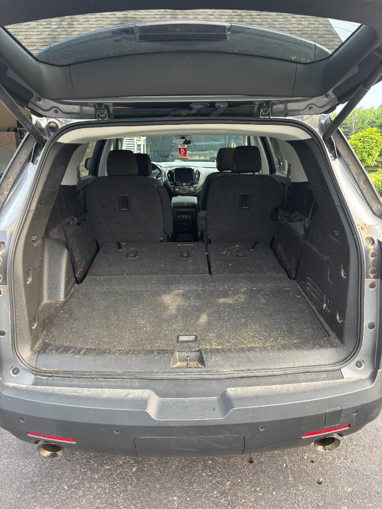 Dirty SUV cargo area with debris and grime before detailing