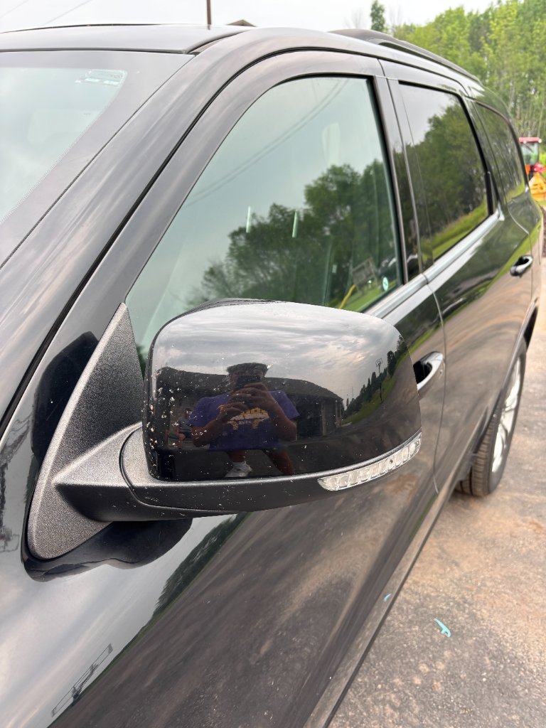 SUV mirror with water spots and contamination before detailing