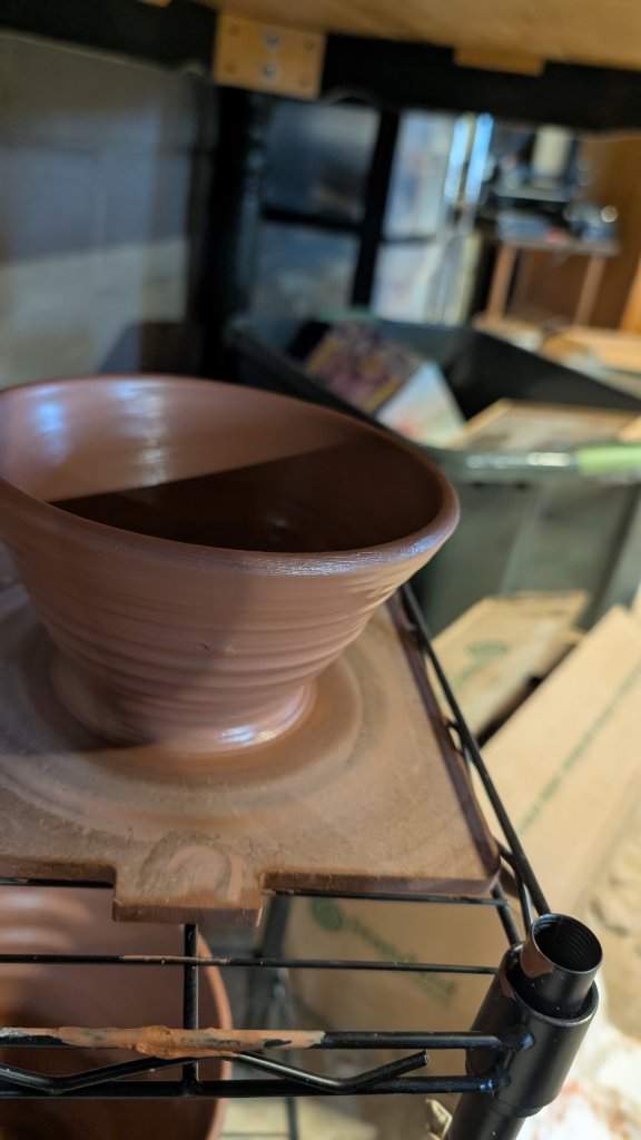Flared clay bowl on wire rack