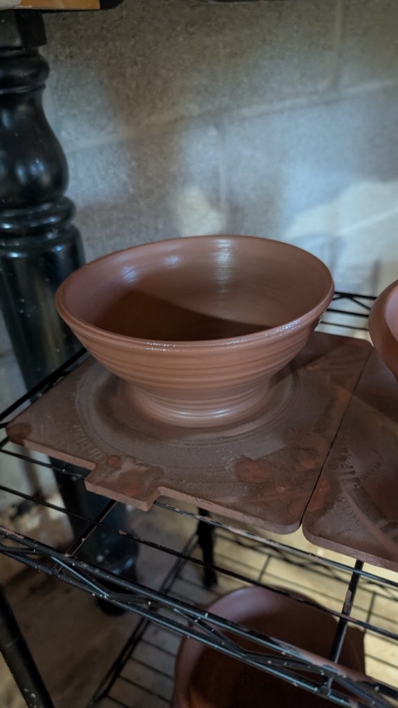 Terracotta bowl drying on rack