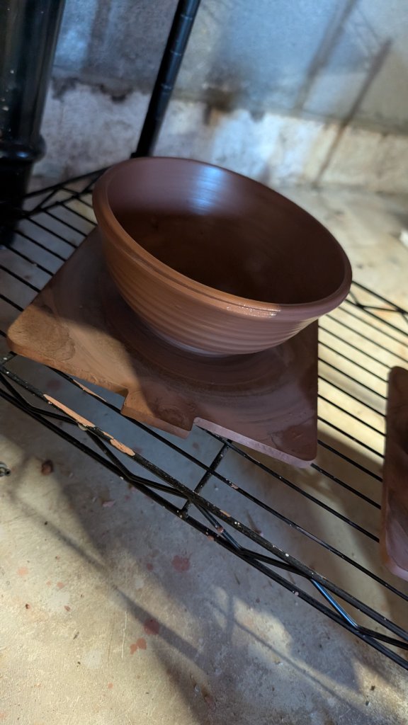 Terracotta bowl drying on shelf