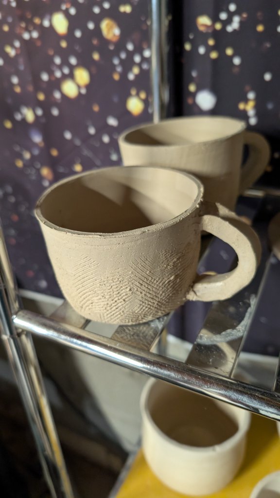 Fingerprint-textured unfired clay mug