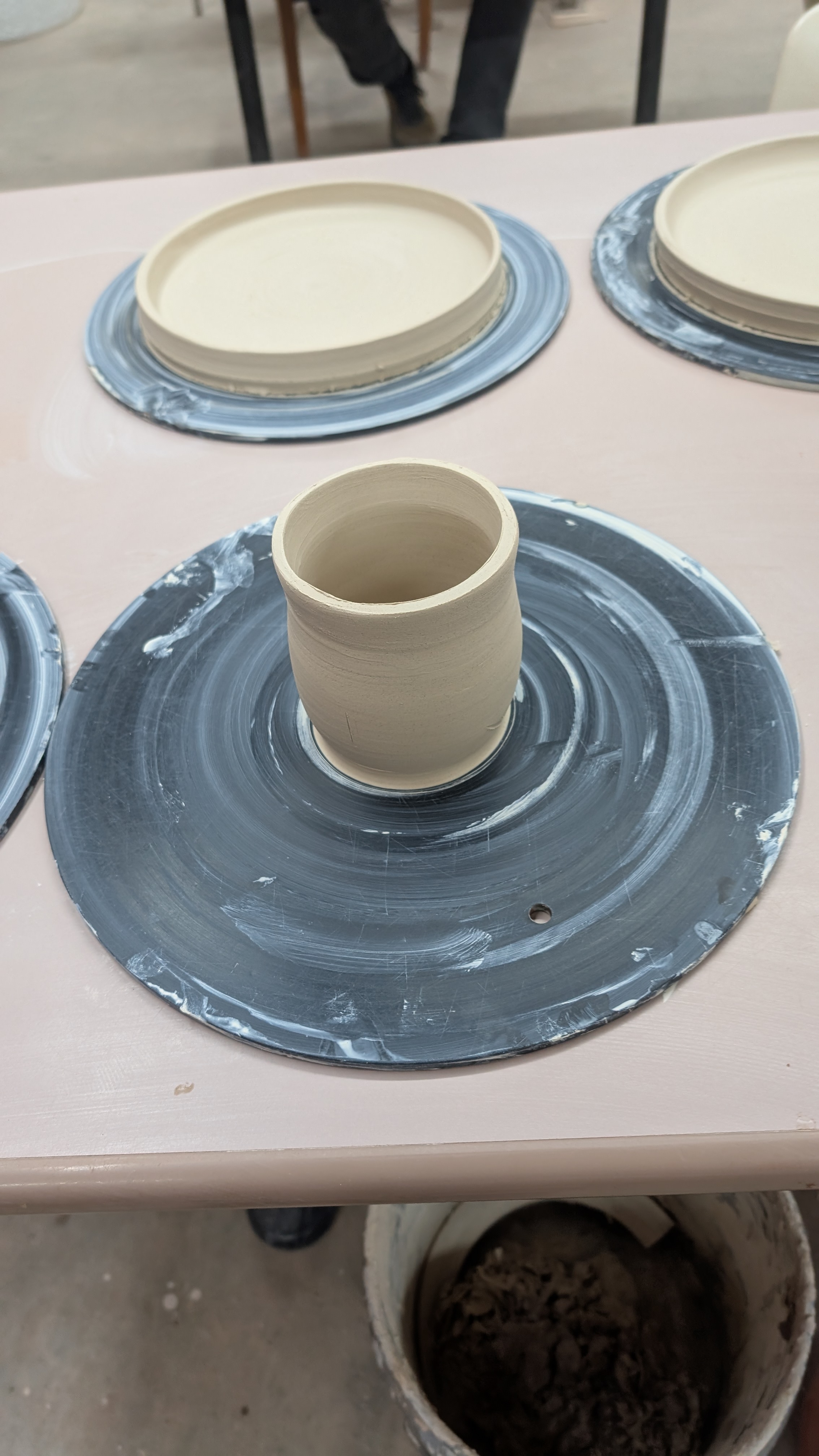 Freshly thrown clay cup on wheel bat
