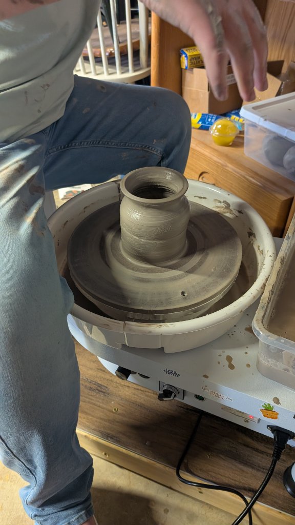 Small vase being thrown on wheel