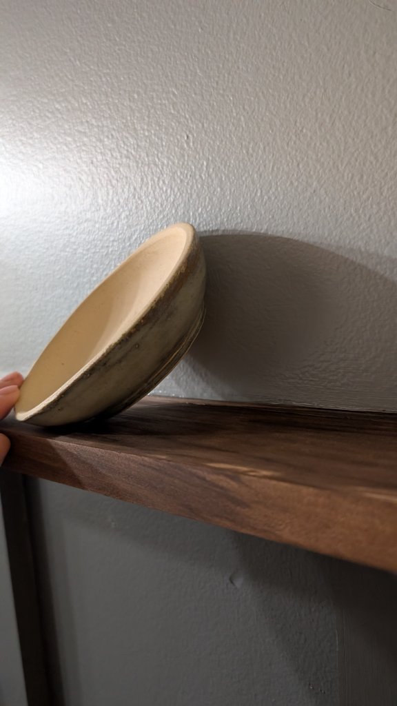 Cream glazed bowl on shelf