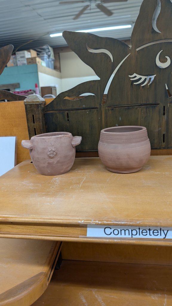 Two small clay pots in studio