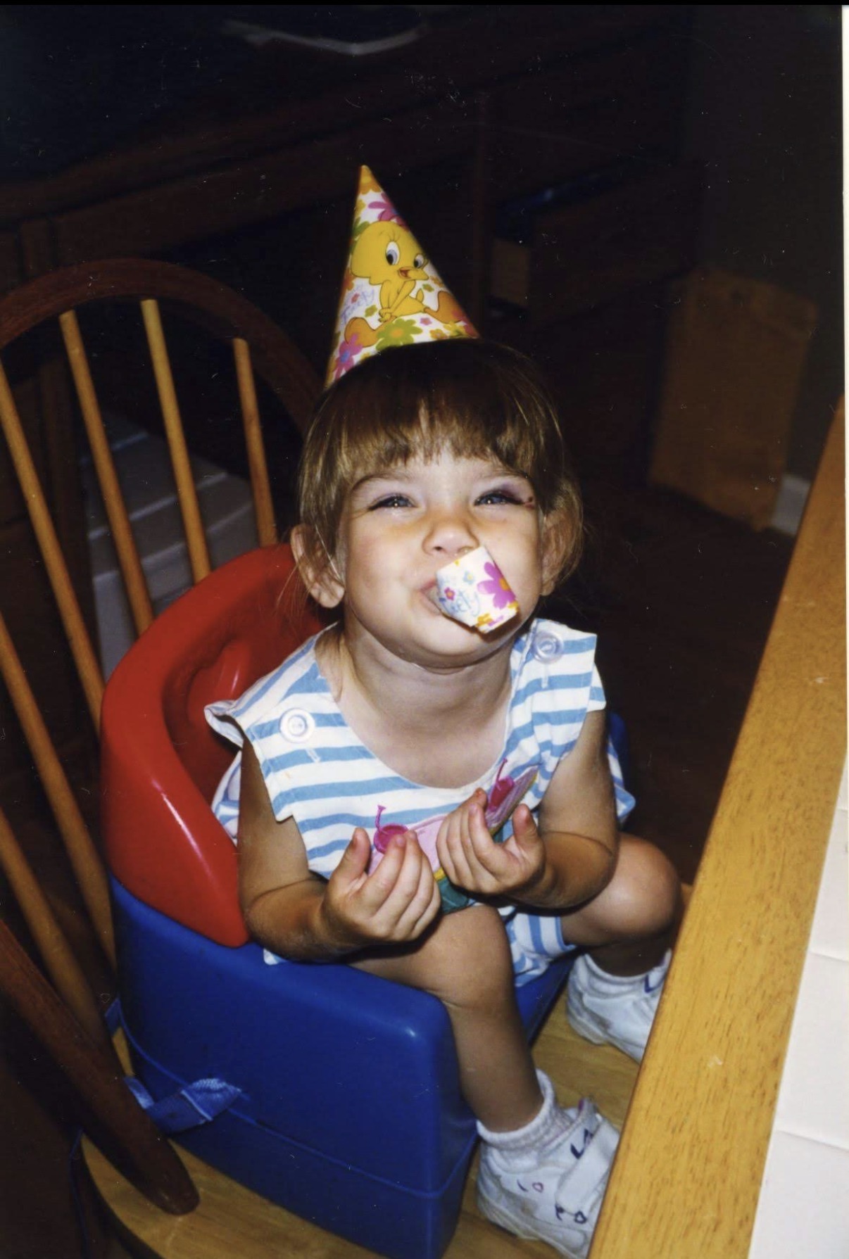Little Allie celebrating in her birthday hat