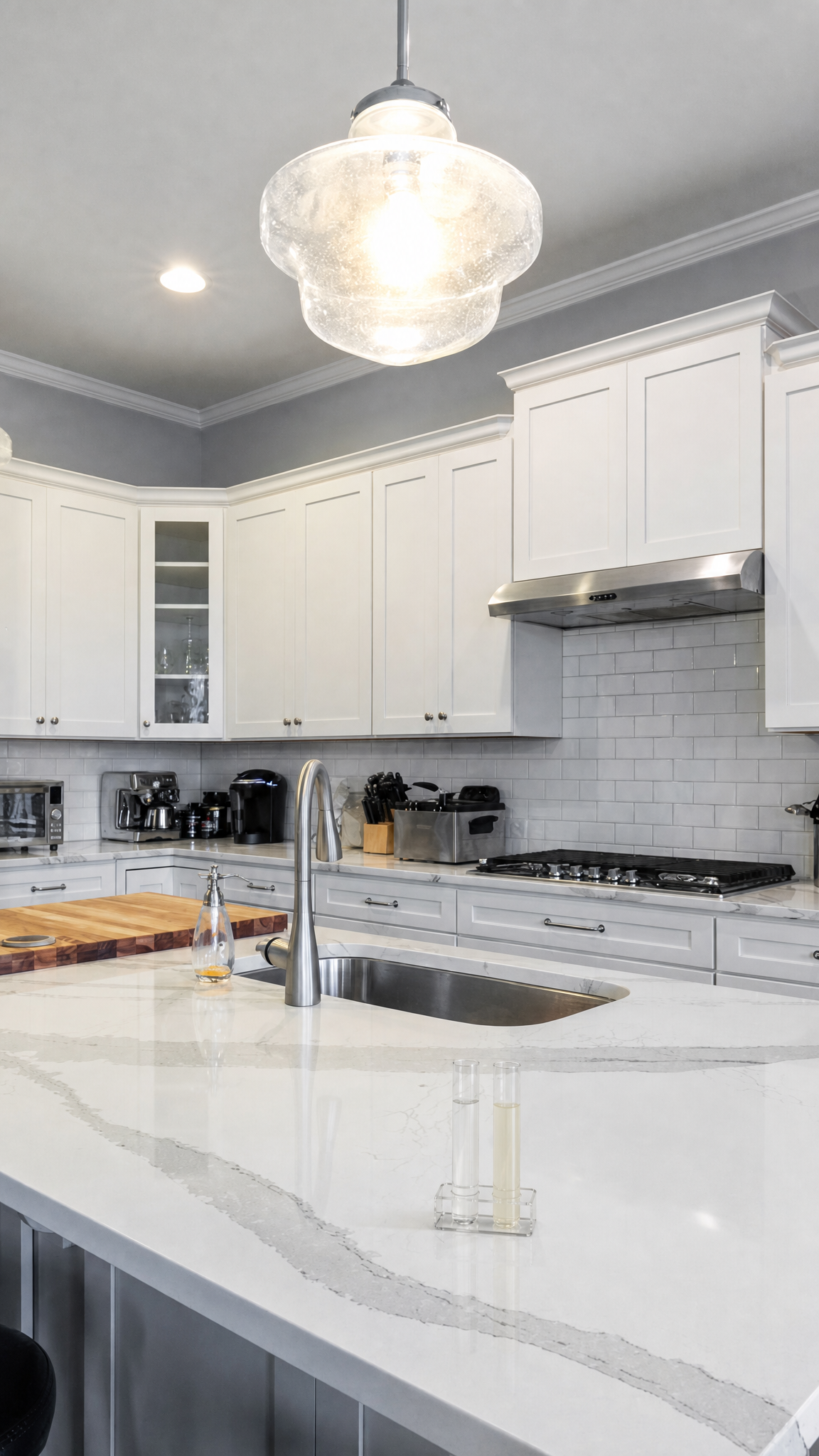 Modern kitchen with polished quartz countertop and stainless steel fixtures