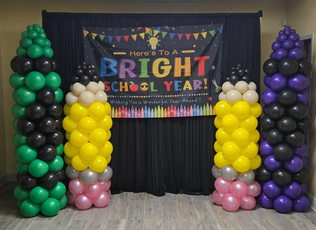 Back to school balloon display with pencil columns and a colorful banner