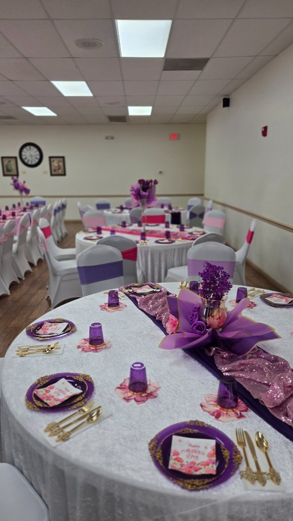 Purple and pink Mother's Day banquet table with sequin runner, floral centerpiece and gold-rimmed charger plates