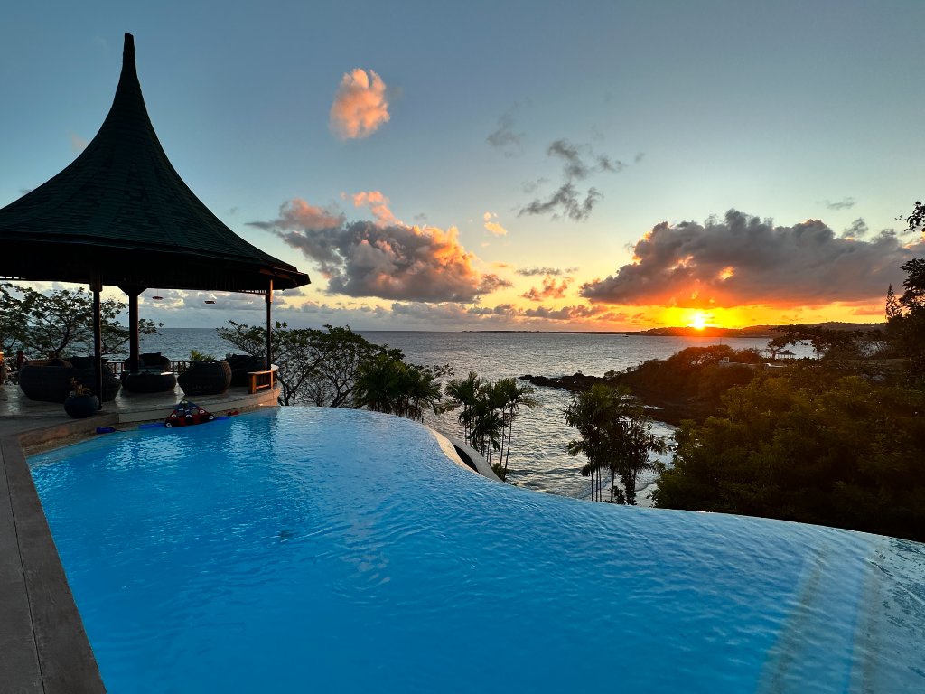 Infinity pool at sunset with Caribbean view