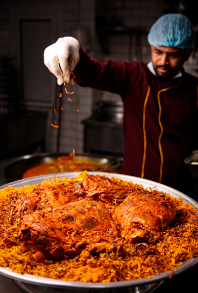 Premium spices and long-grain rice on dark stone surface