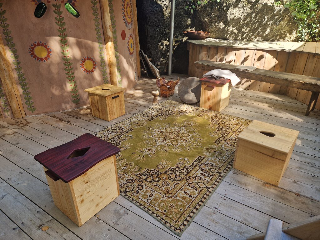 Handcrafted yoni steam seats arranged on a wooden deck