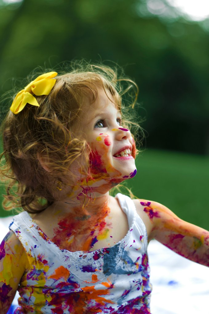 Happy child with colorful paint