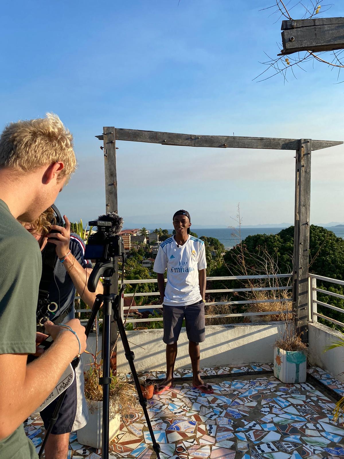 Interns filming an interview on a rooftop