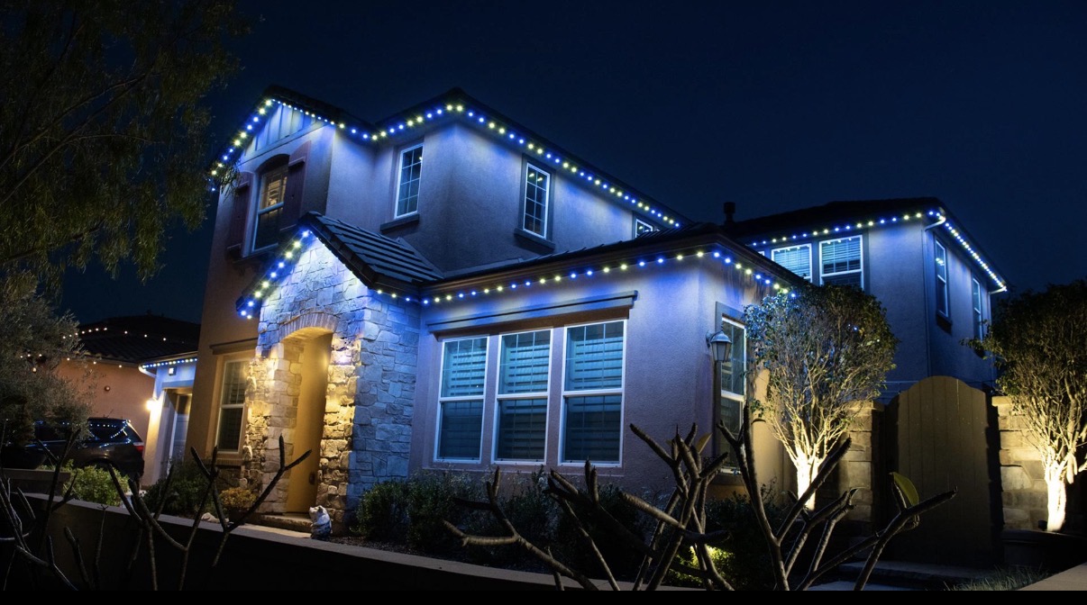 Permanent blue roofline lighting on a home