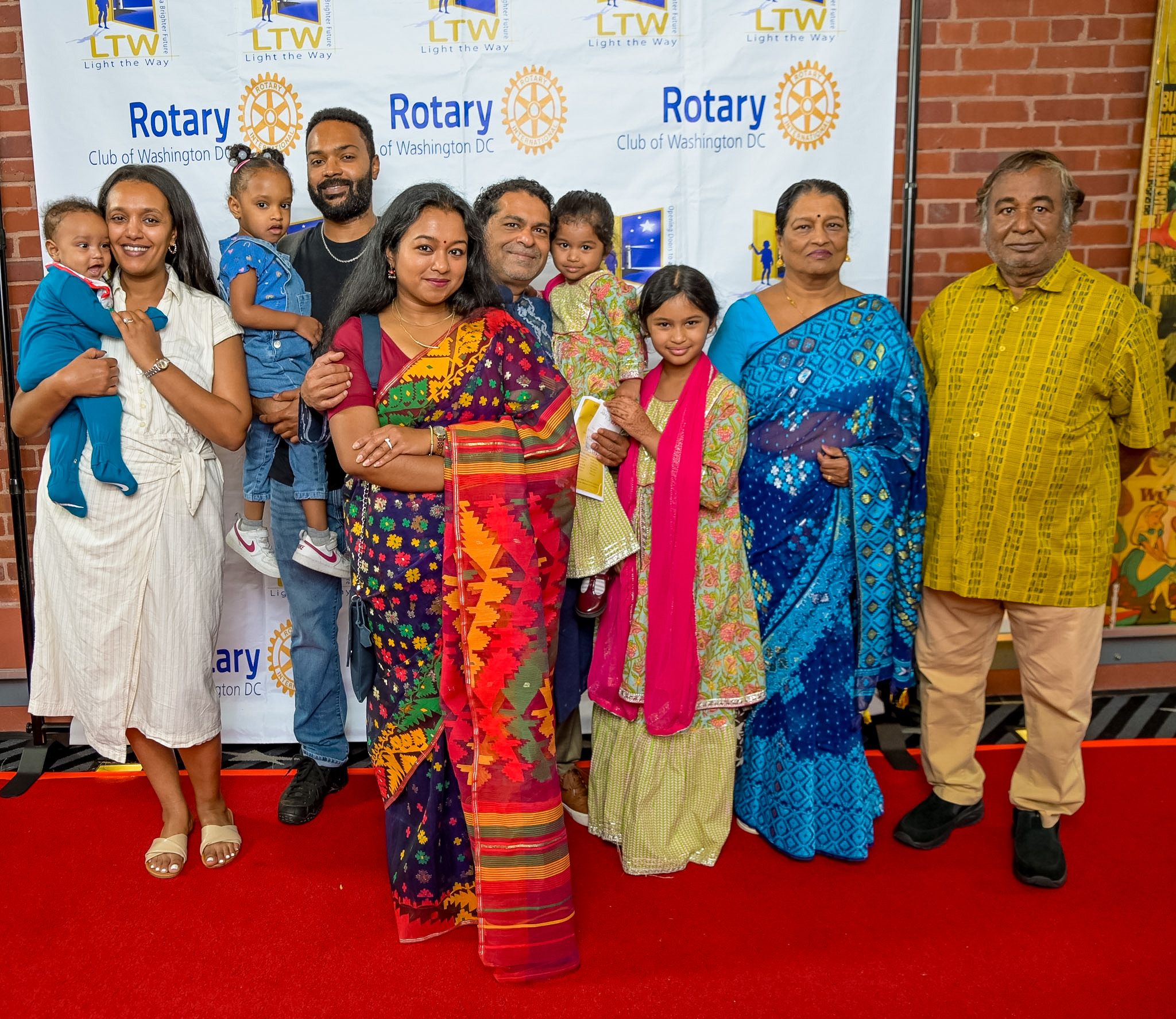 Multi-generational family in formal and traditional attire at the 2026 Red Carpet Premiere