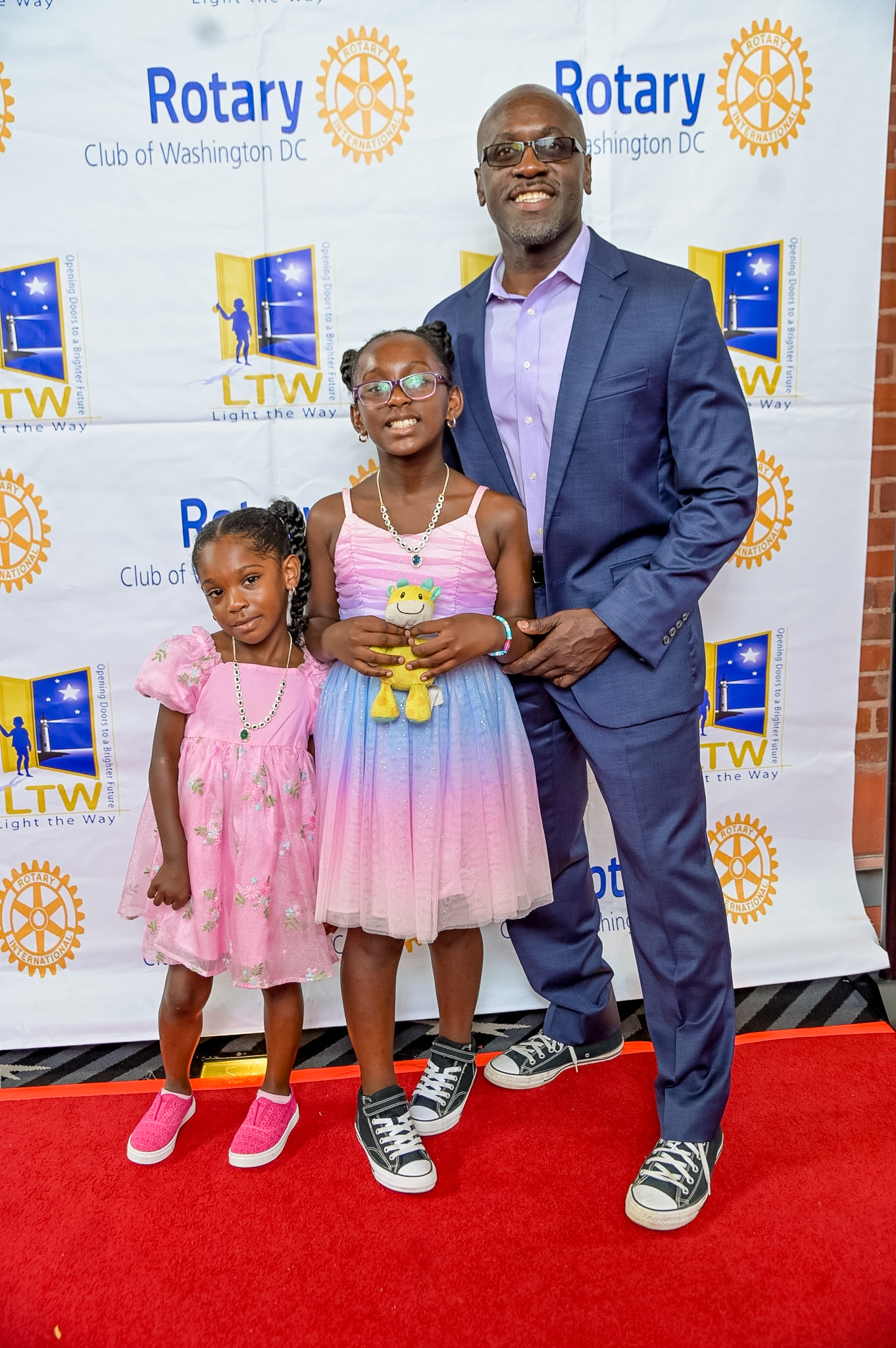 Two girls and a man posing on the Red Carpet at the 2026 Premiere