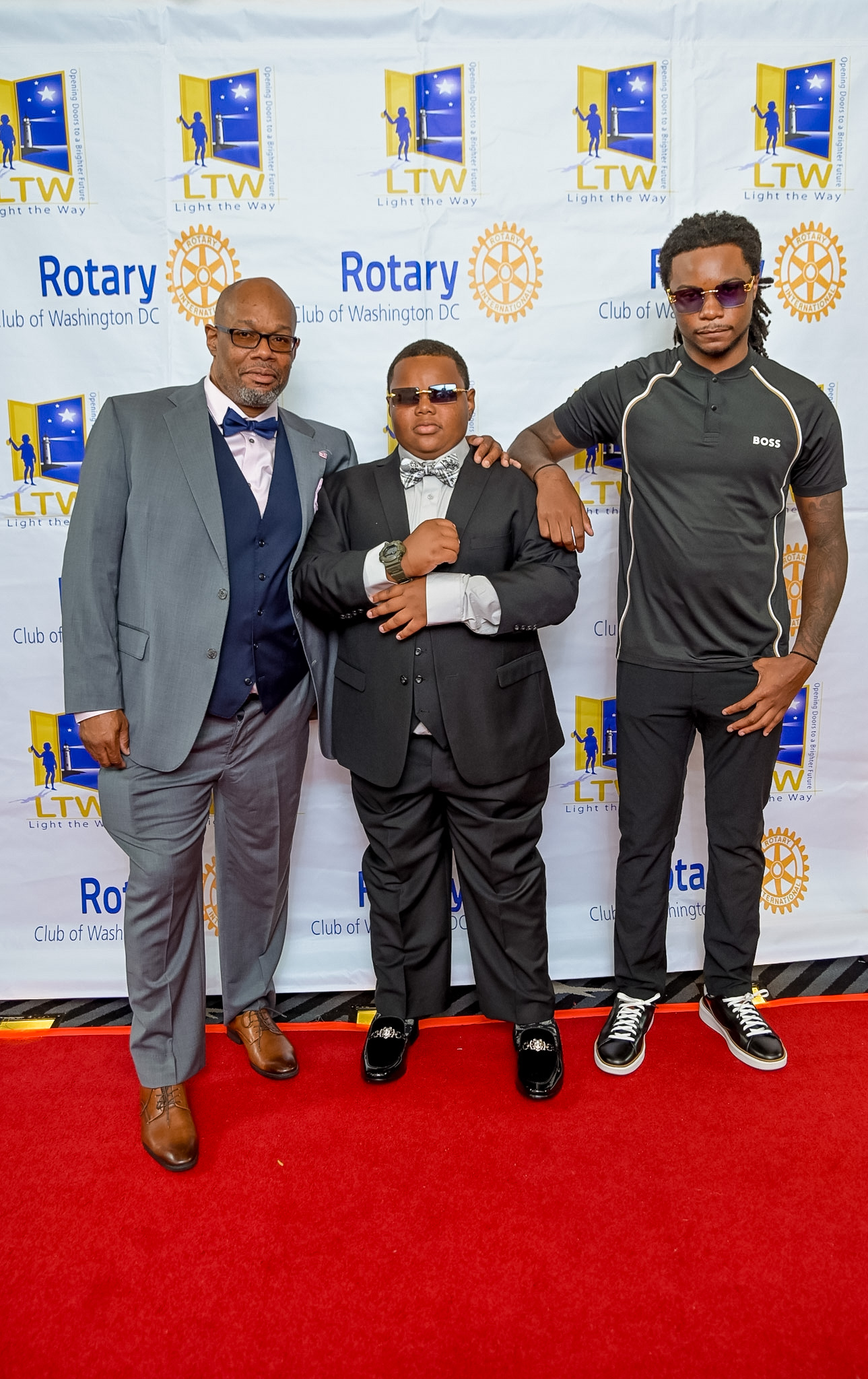 Three men posing together on the Red Carpet at the 2026 Premiere