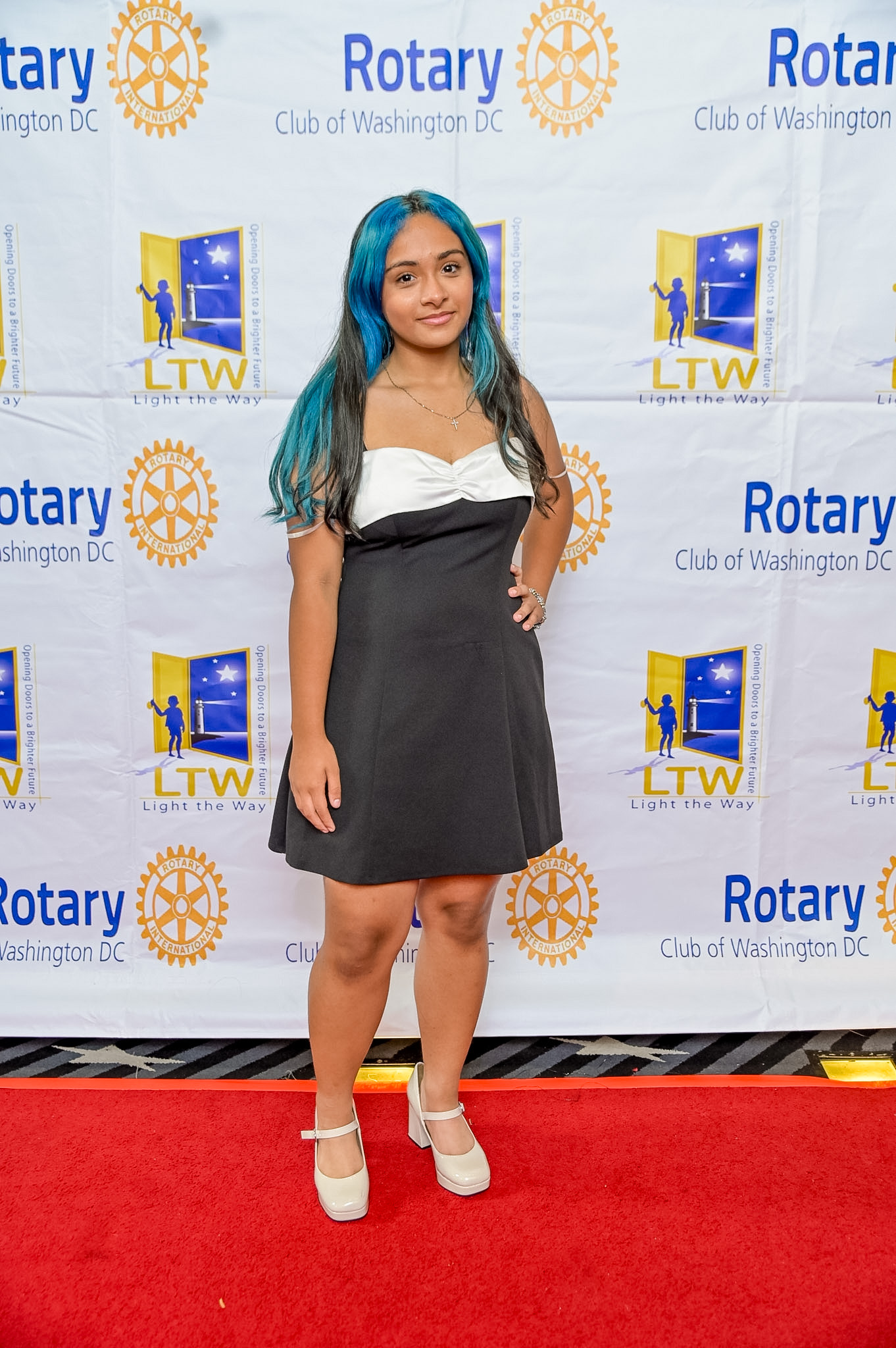 Young woman with blue-streaked hair posing at the 2026 Red Carpet Premiere