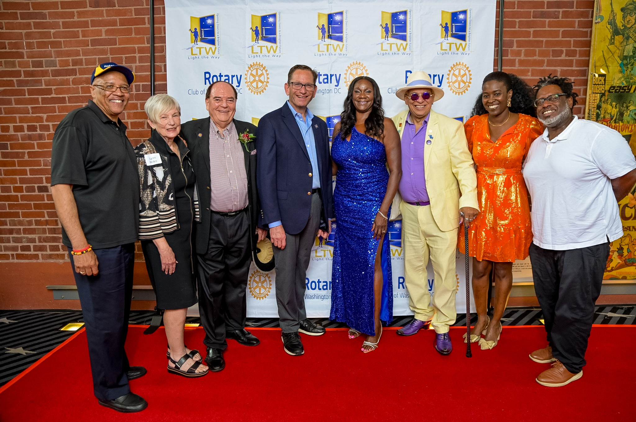 Group of eight guests posing together on the Red Carpet at the 2026 Premiere