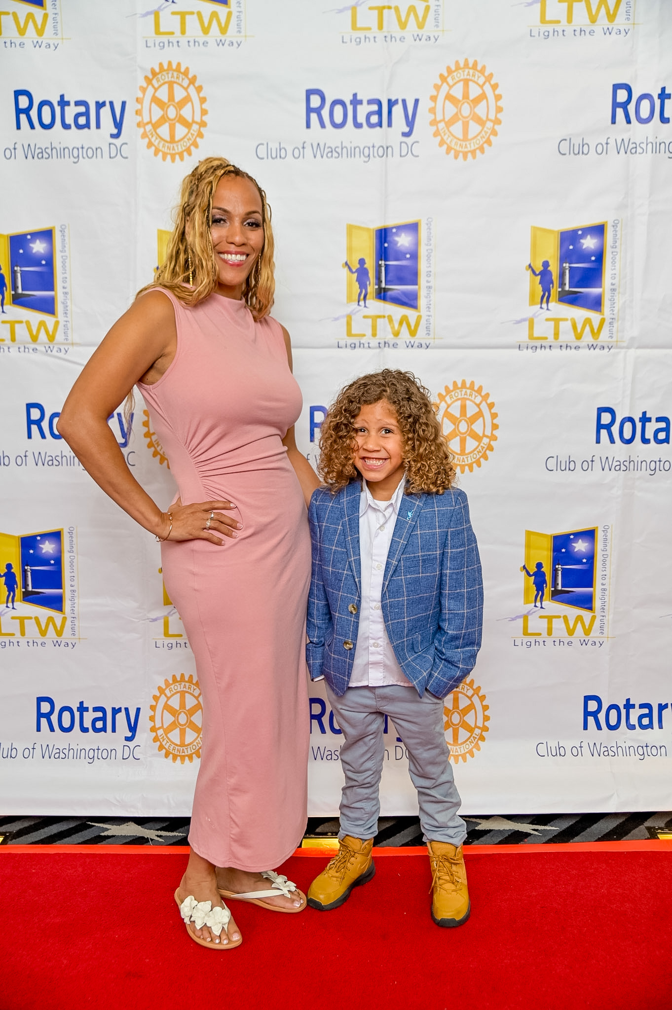 A woman and a young boy posing on the Red Carpet at the 2026 Premiere