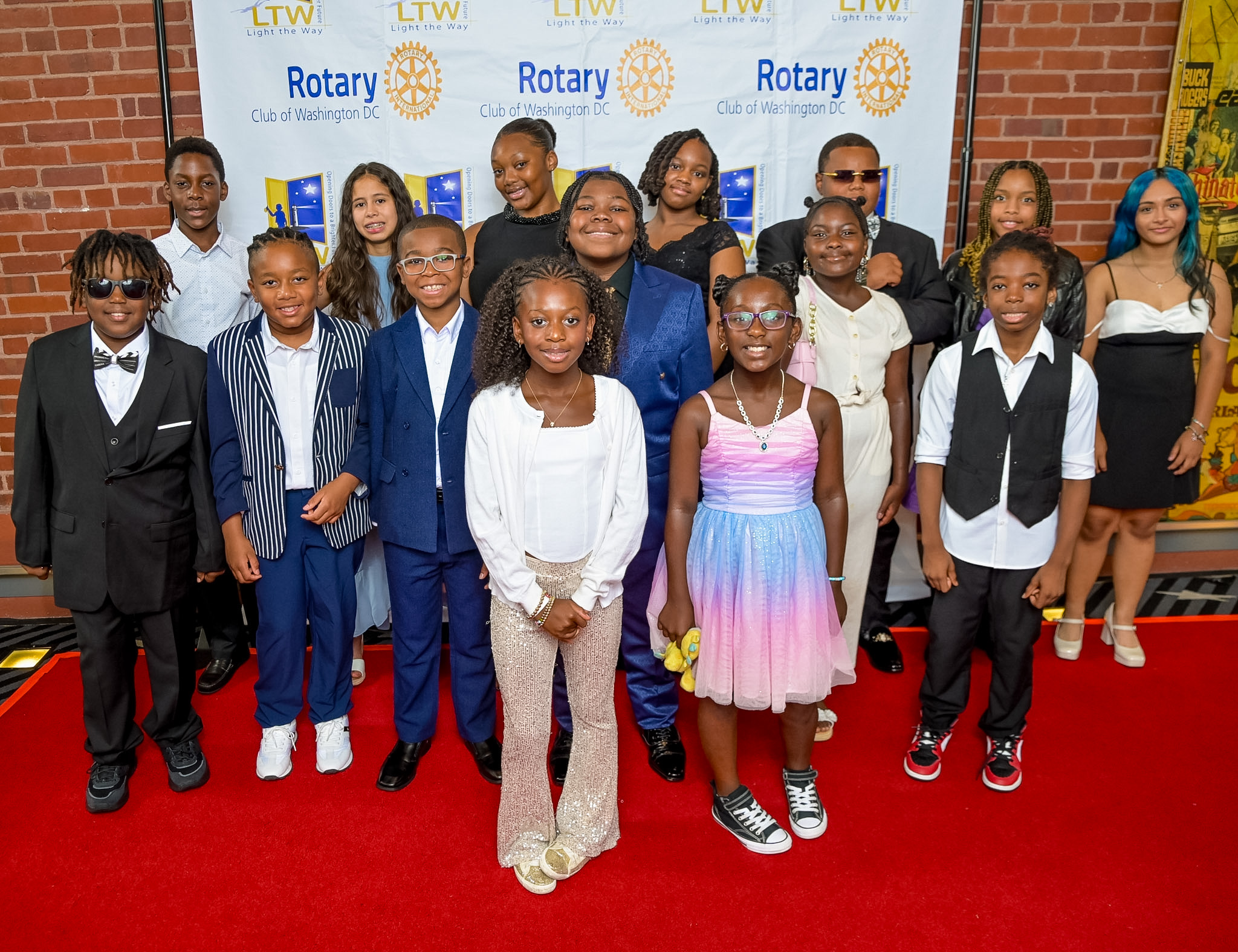 Group of fourteen children posing on the Red Carpet at the 2026 Premiere